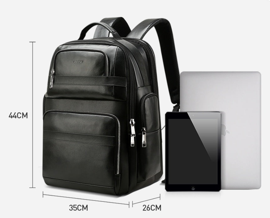 Black backpack with dimensions and a laptop and tablet for scale on a white background