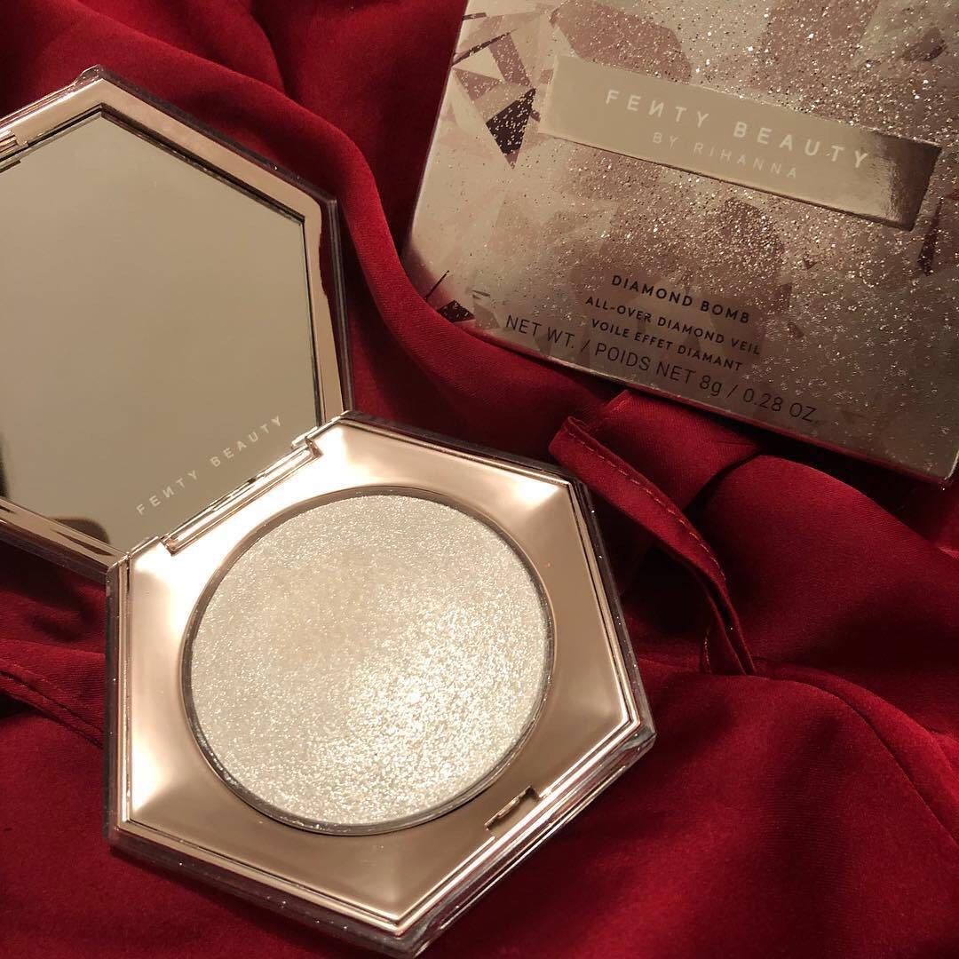 Fenty Beauty product on a red fabric background