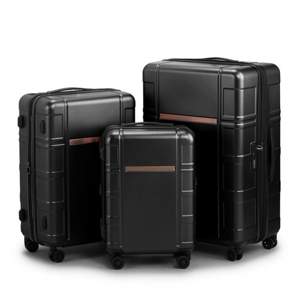 Three black suitcases of different sizes on a white background