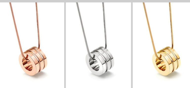 Three gold and silver necklaces with interlocking rings on a white background
