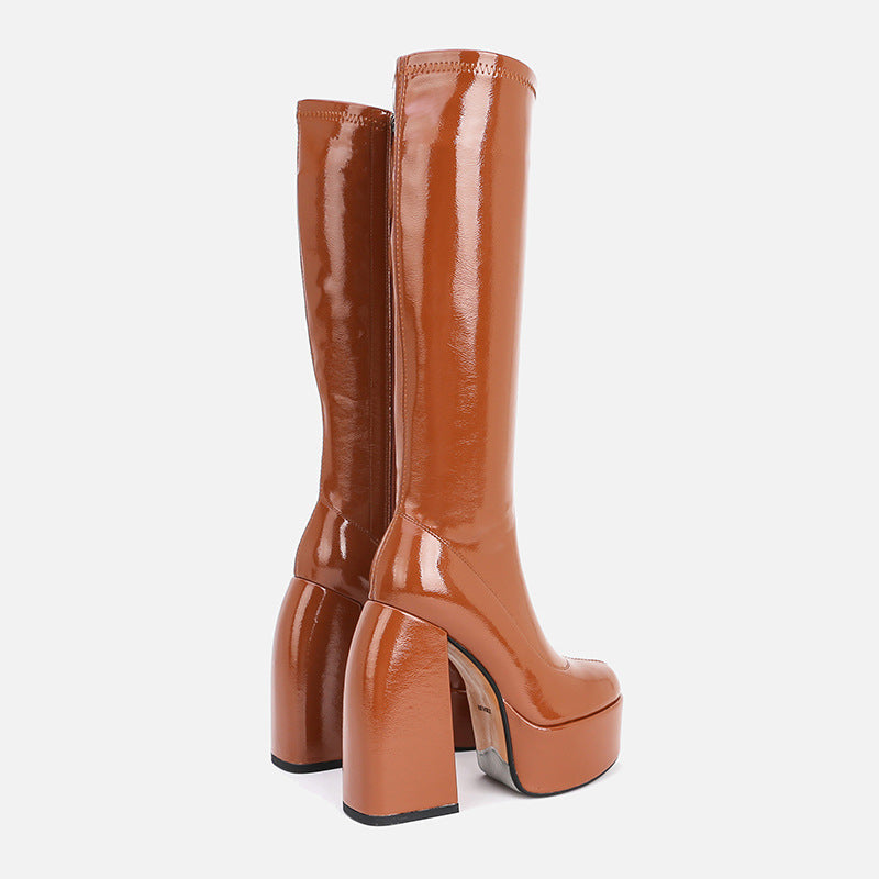 Brown platform knee-high boots on a white background