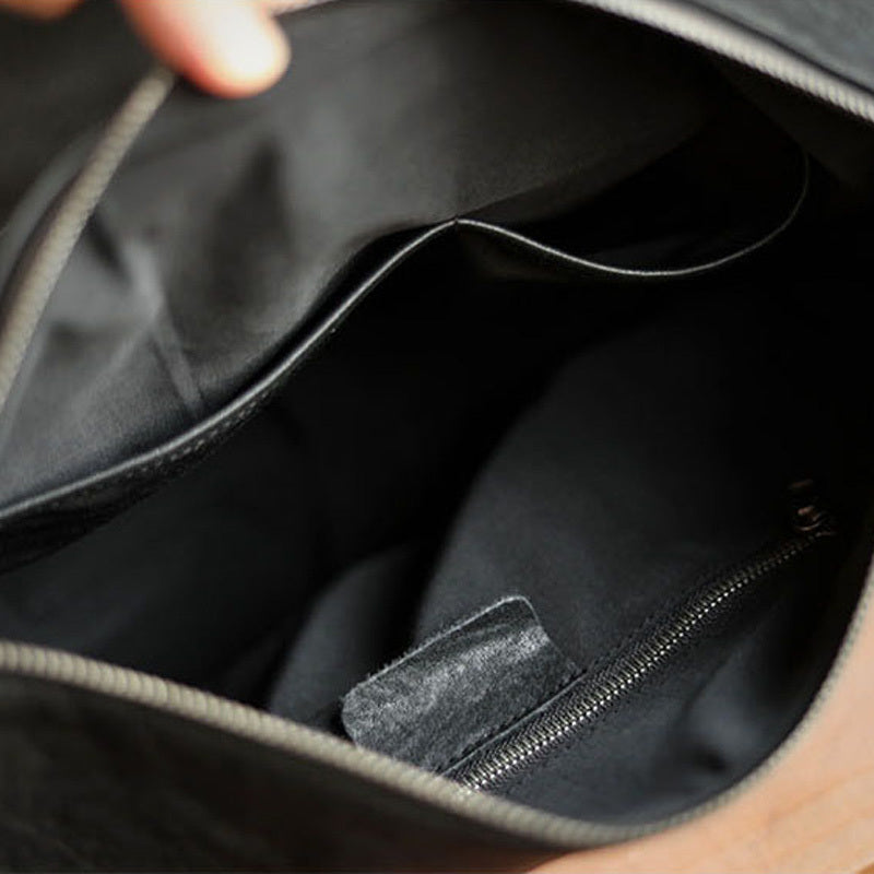 Close-up of a black bag interior with a zipper