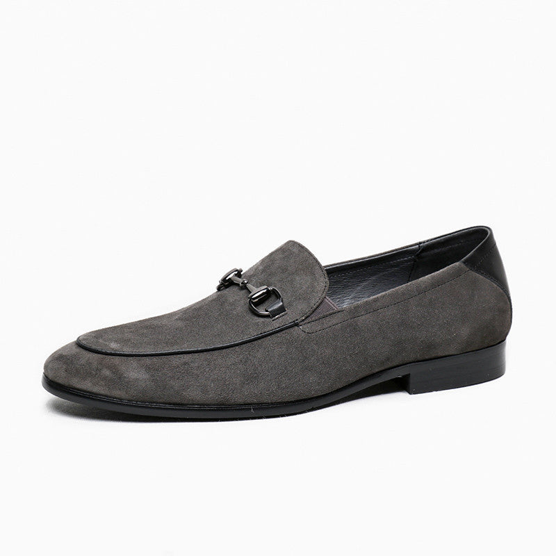 Gray suede loafer with a black sole on a white background