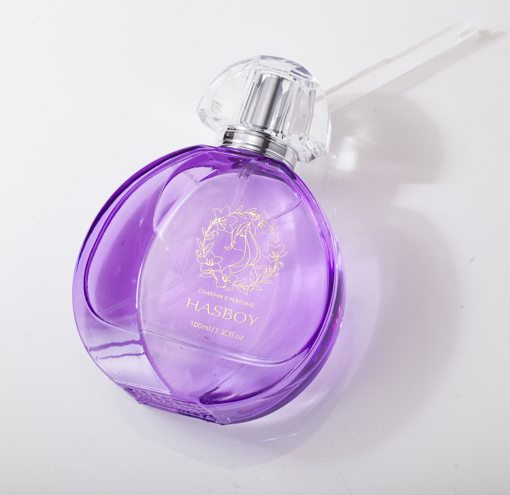 Purple perfume bottle with silver cap on a white background