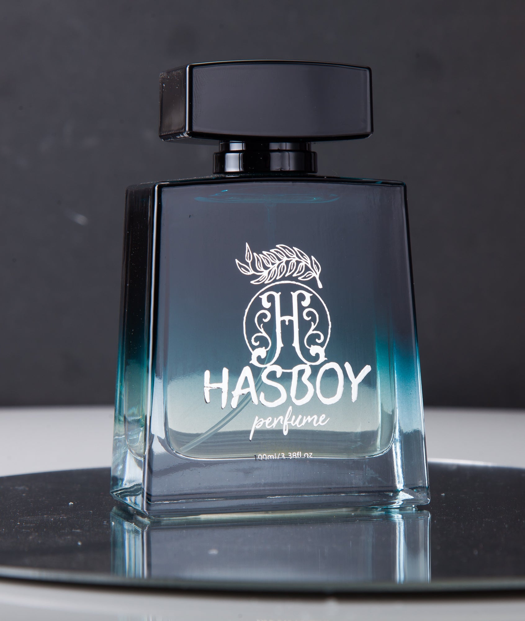 Hasboy perfume bottle on a reflective surface with a dark background