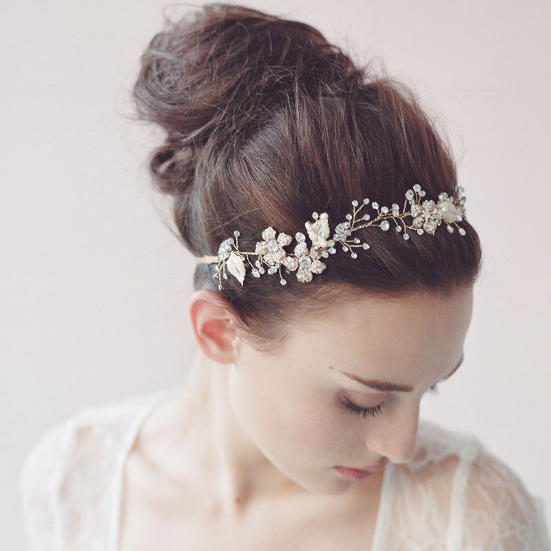 Woman wearing a decorative headband with a plain background