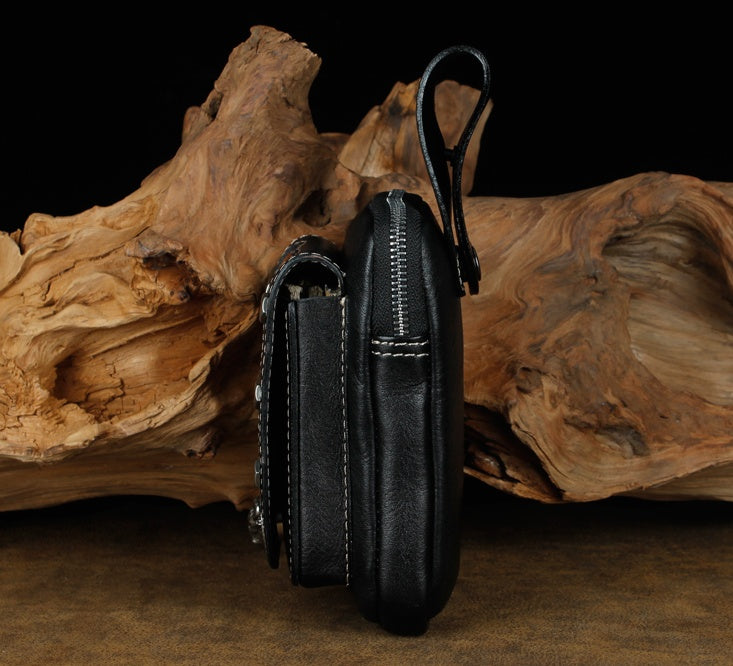 Black leather wallet with zipper on a wooden background