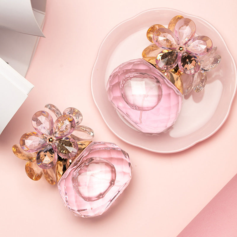 Pink glass flower-shaped objects on a pink surface