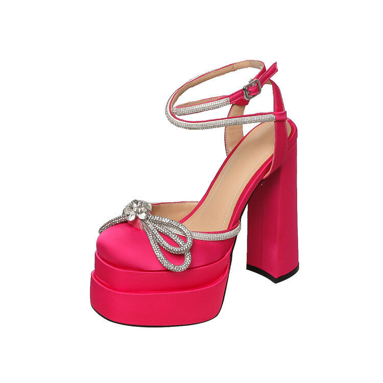 Pink high-heeled shoe with embellishments on a white background