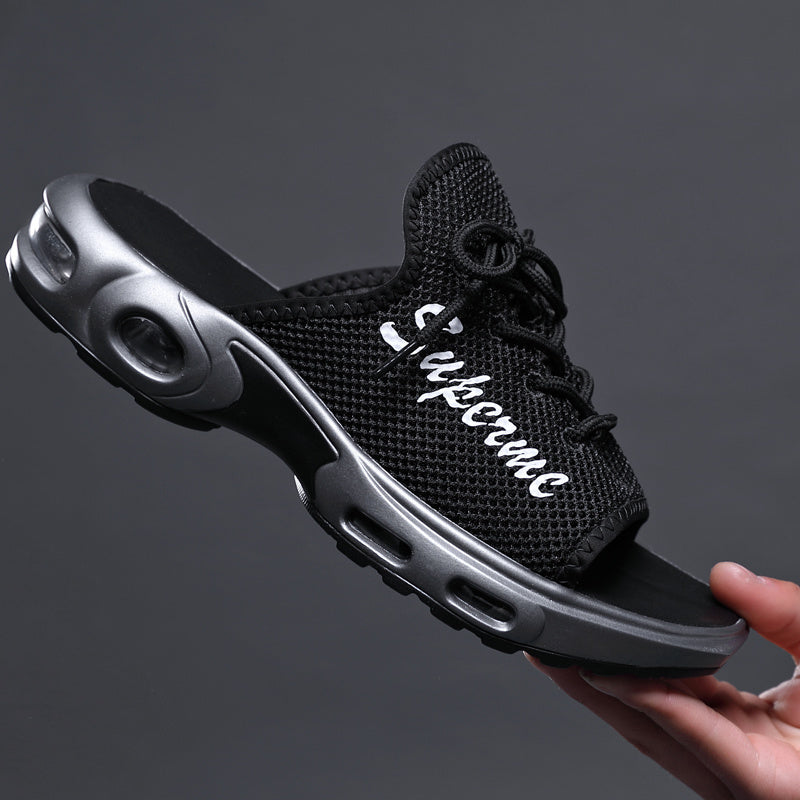Black sneaker with 'Supreme' branding held by a hand against a dark background