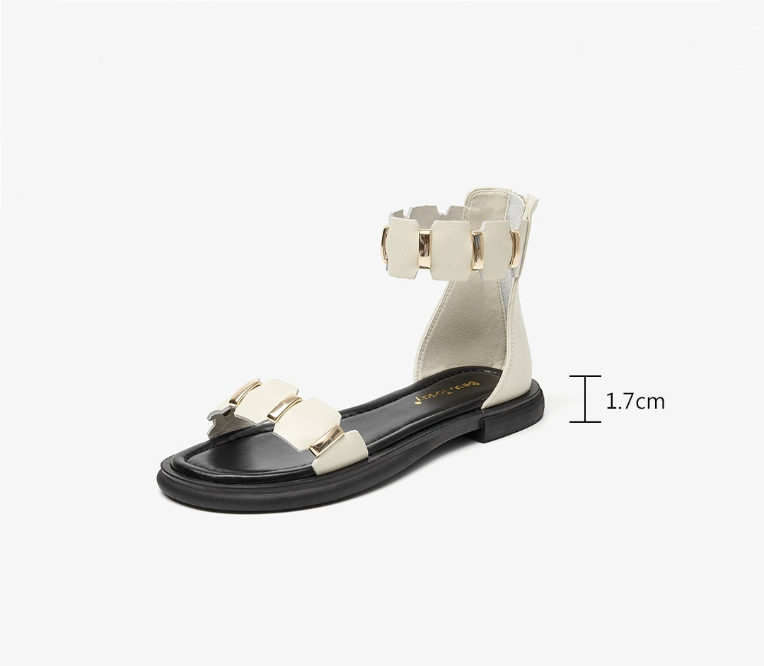 Black sandal with white bow design on a white background