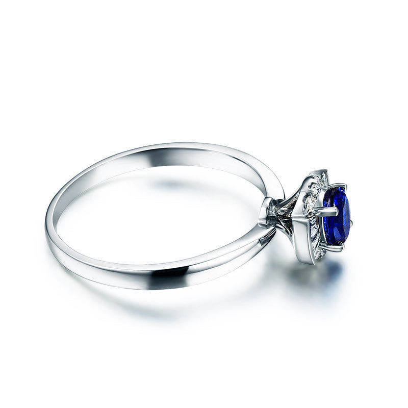 Silver ring with a blue gemstone on a white background