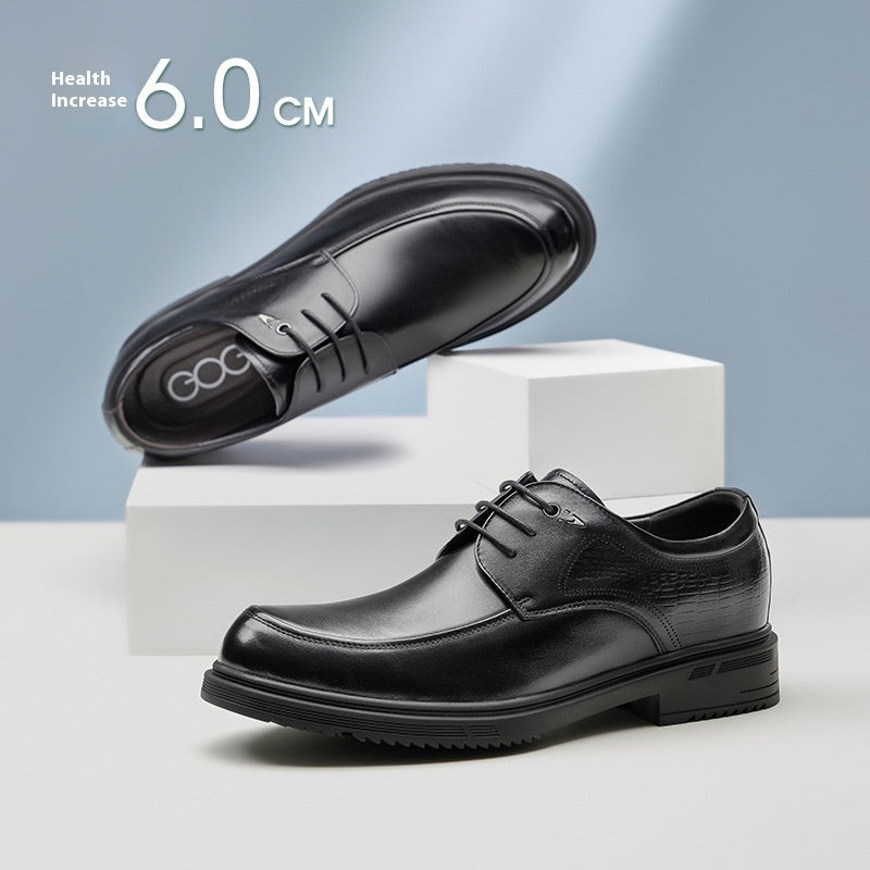 Black dress shoes on a white platform with a light blue background