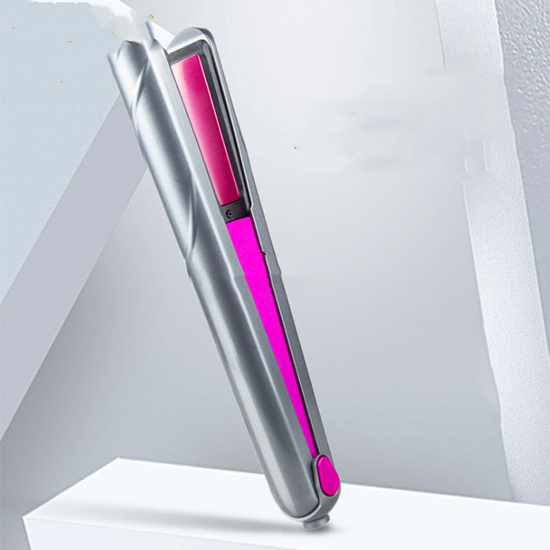 Silver and pink hair straightener on a light gray background