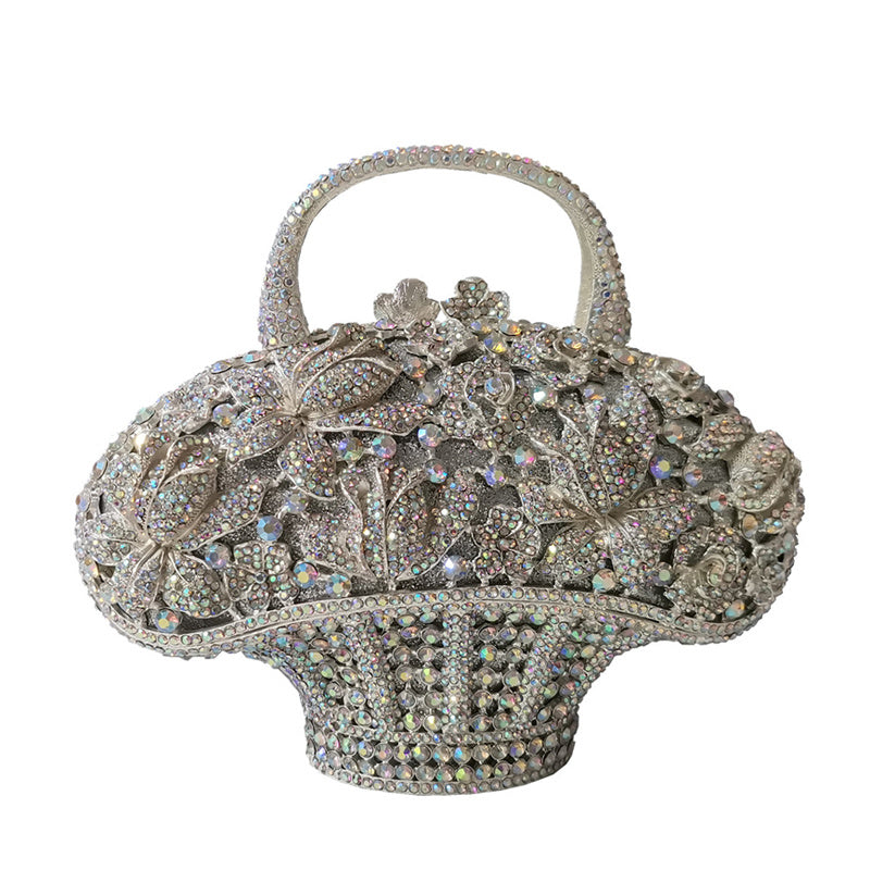 Elegant handbag with intricate design and sparkling stones on a white background