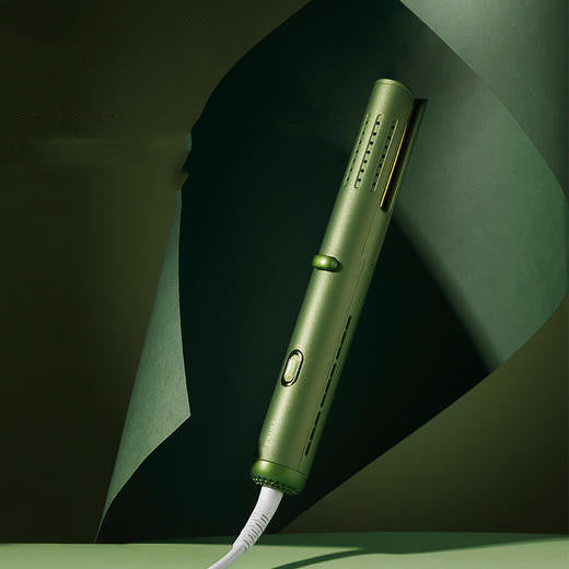 Green hair straightener on a dark green background
