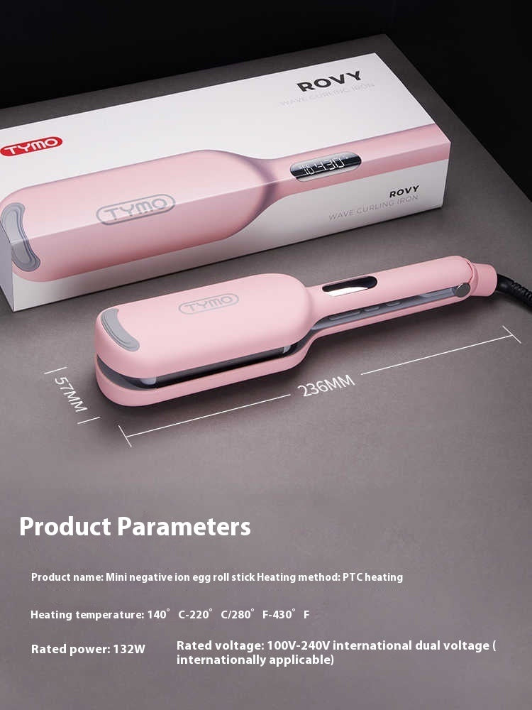 Pink hair straightener with packaging on a gray surface, showing product parameters.