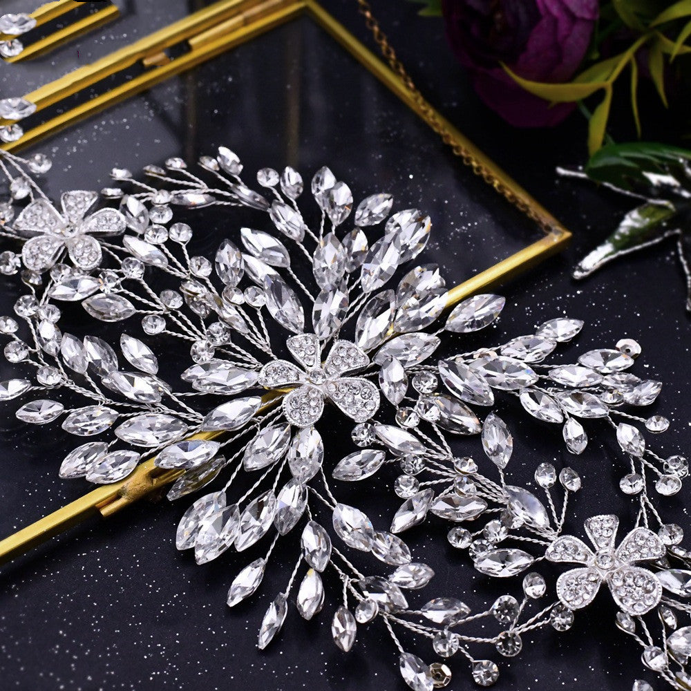 Silver floral hairpin with crystal details on a black background