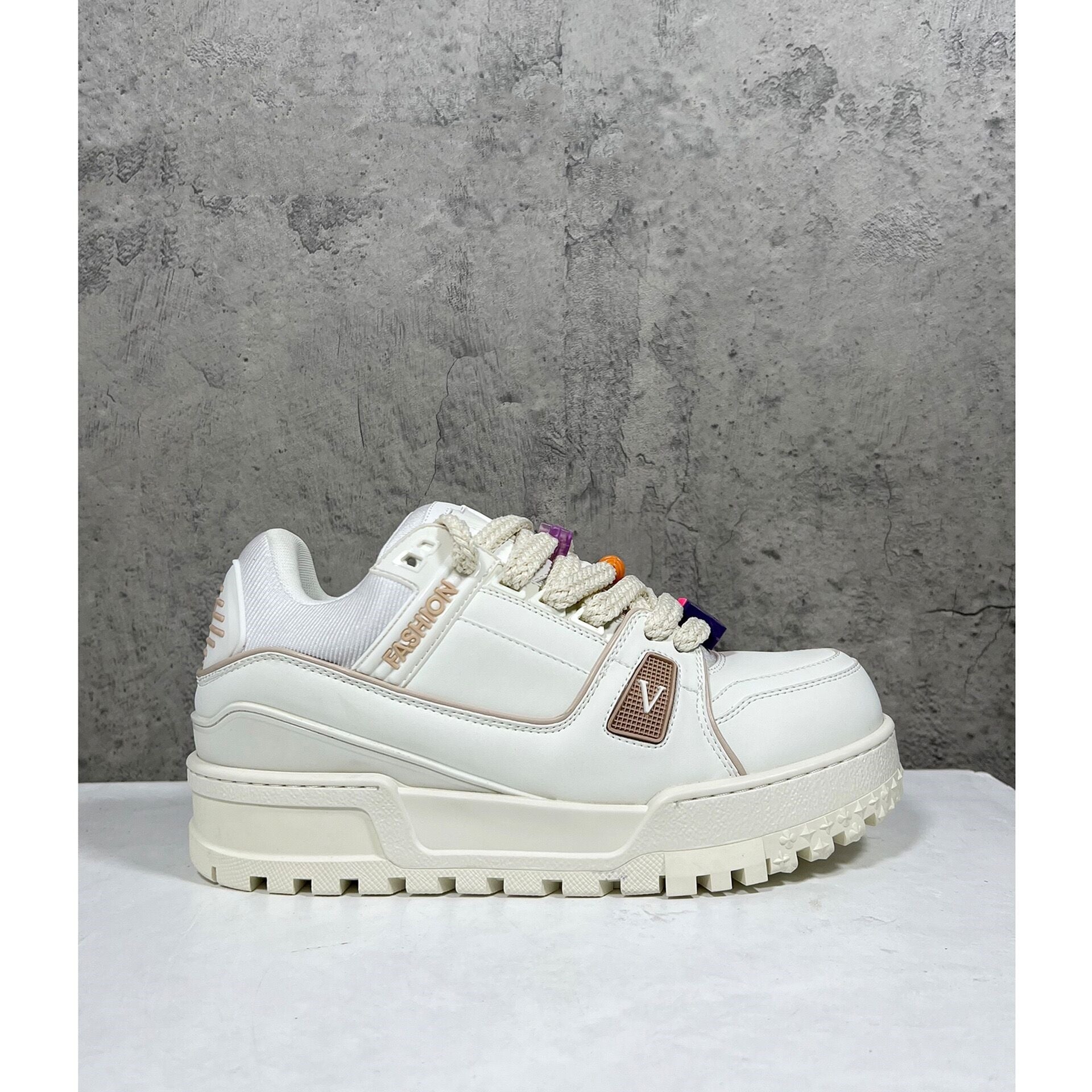White sneaker with colorful accents on a gray background