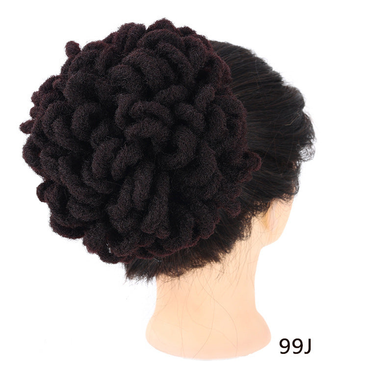 Black braided hairpiece on a mannequin head with a white background