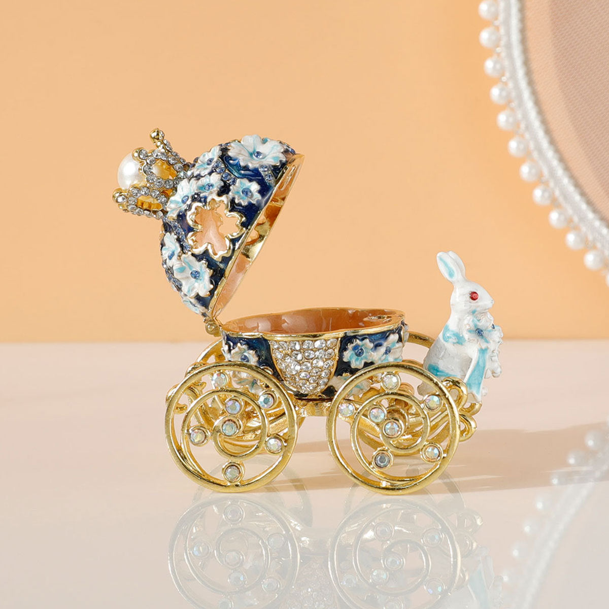 Decorative baby carriage with a rabbit figure on a reflective surface
