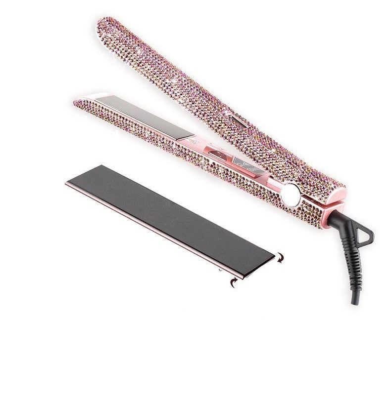 Pink hair straightener with rhinestone embellishments on a white background