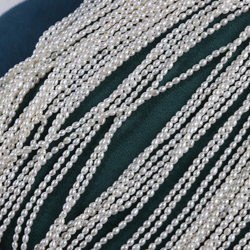 Multiple strands of pearls on a dark fabric background