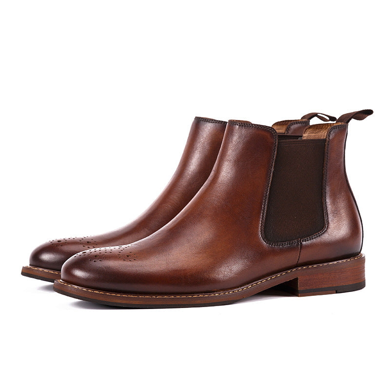 Pair of brown leather Chelsea boots on a white background