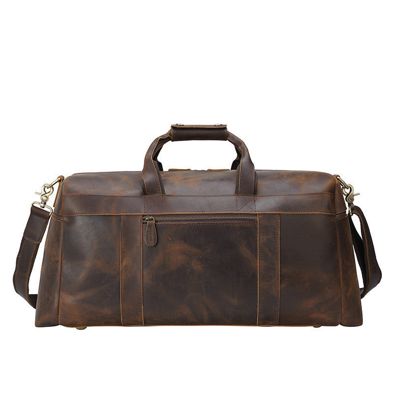 Brown leather duffel bag with shoulder strap on a white background