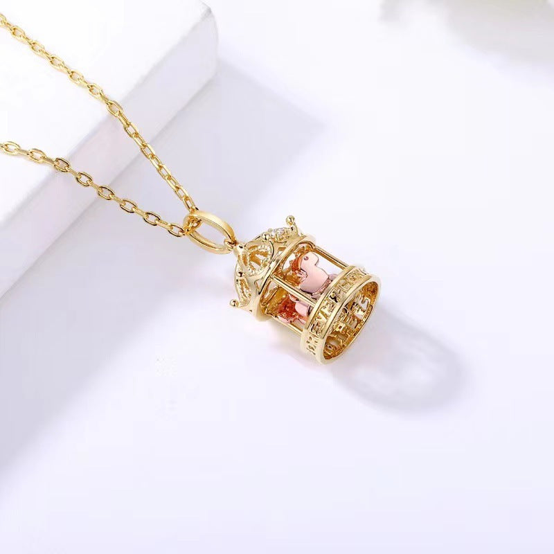 Gold necklace with a decorative pendant on a white background