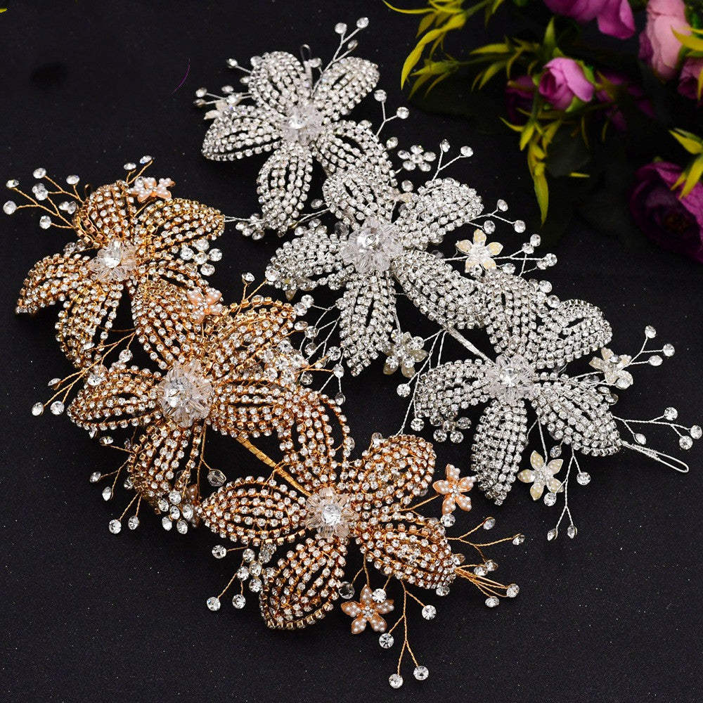 Three decorative butterfly pins in gold, silver, and rose gold on a dark background.