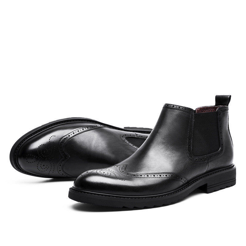 Pair of black leather Chelsea boots on a white background