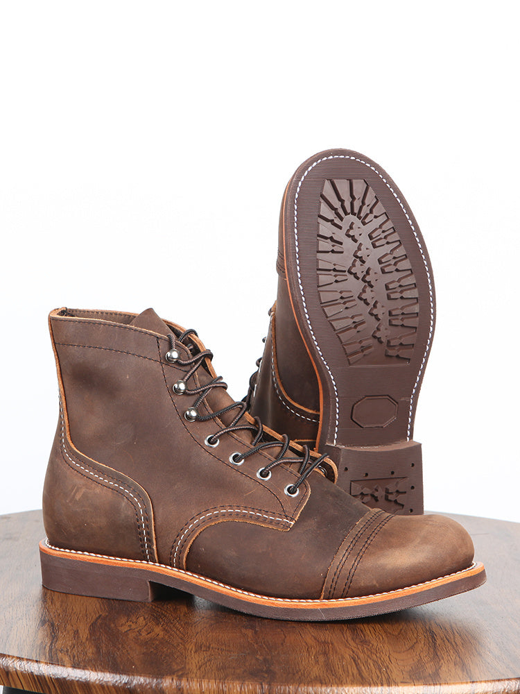 Brown leather boot with a focus on the sole on a wooden surface