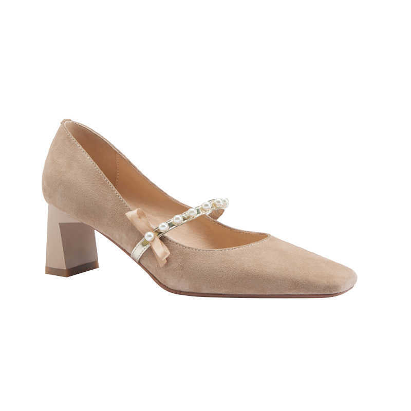 Beige shoe with a decorative strap on a white background