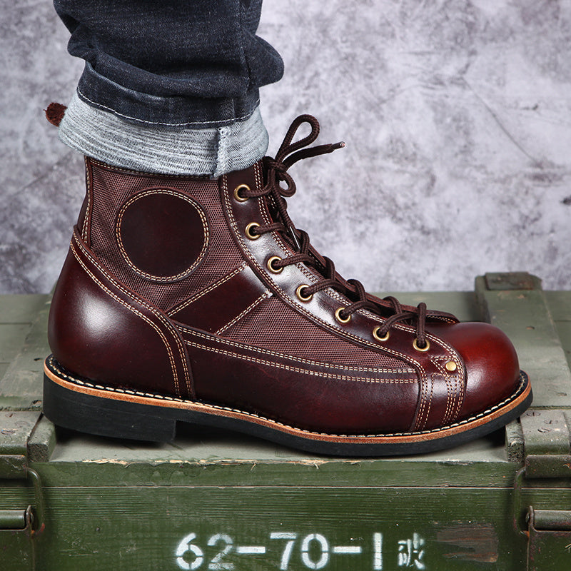 Brown leather boot with gold laces on a green metal box against a gray background