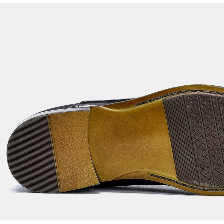 Close-up of a shoe sole with brown leather and black rubber on a white background