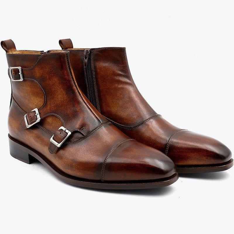 Pair of brown leather boots with buckles on a white background