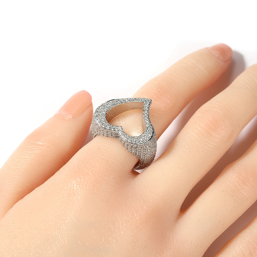 Silver ring with gemstones on a hand against a white background