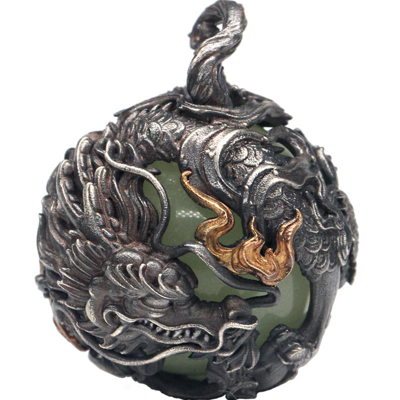 Decorative pendant with intricate designs on a white background