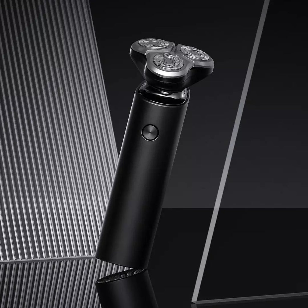 Black electric shaver on a reflective surface with a geometric background