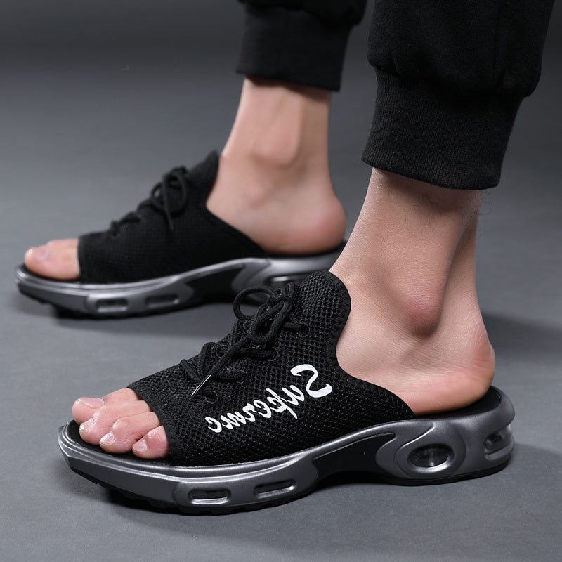 Black sandals with white text on a gray background