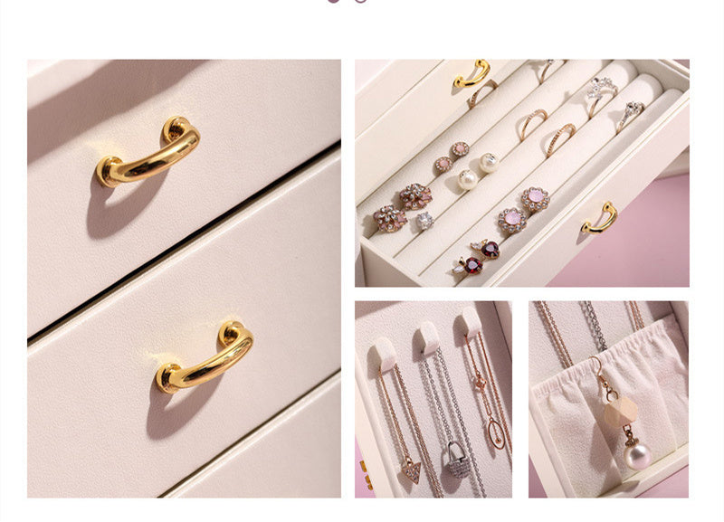 Jewelry set with gold handles on a pink drawer and various jewelry items displayed.
