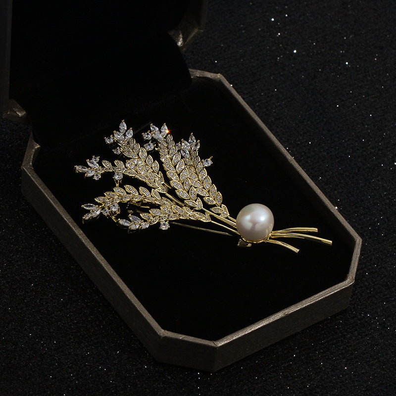 Decorative brooch with pearls and crystals in a black display box