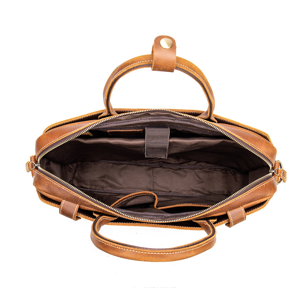 Brown leather bag with open front compartment on a white background