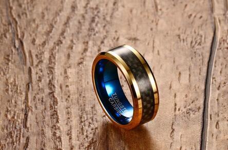Gold and black ring with blue interior on a wooden surface