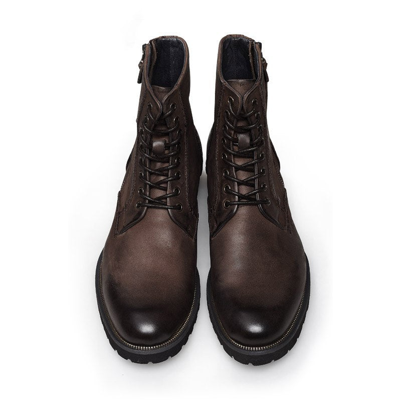 Pair of brown leather boots on a white background
