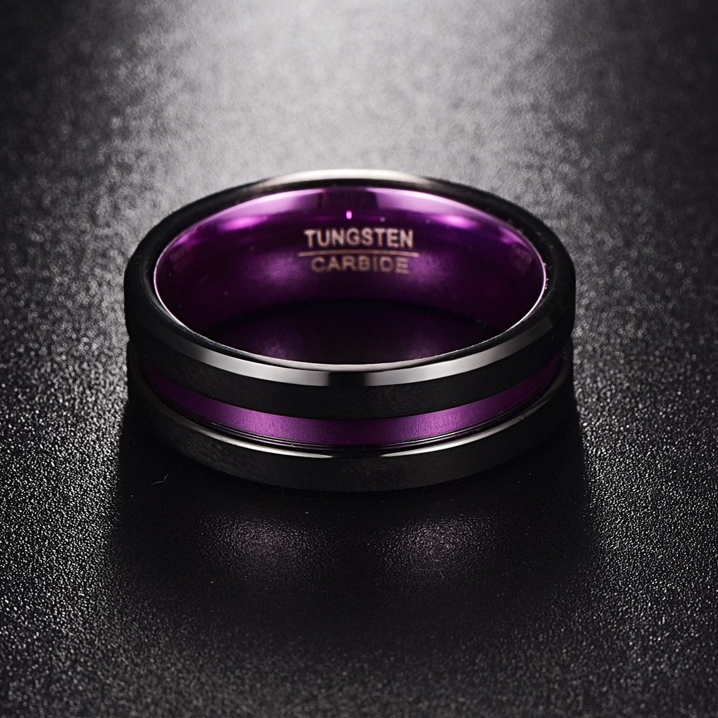 Tungsten carbide ring with purple interior on a dark textured background