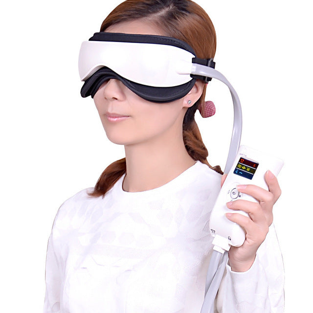 Person wearing a white eye mask with a handheld device on a white background