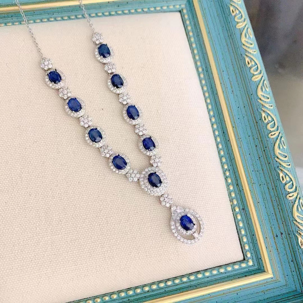 Elegant necklace with blue gemstones on a decorative stand