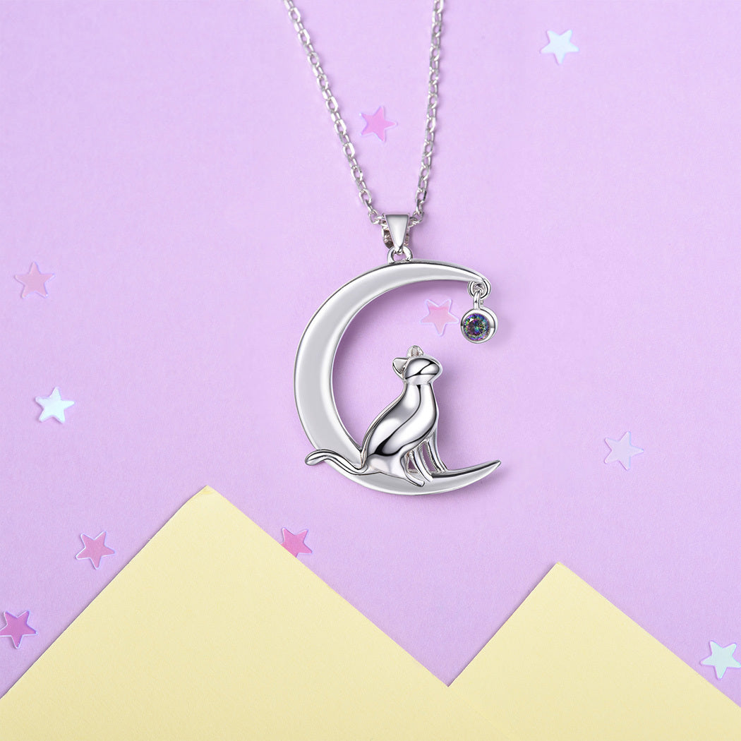 Silver necklace with a moon and cat pendant on a purple background